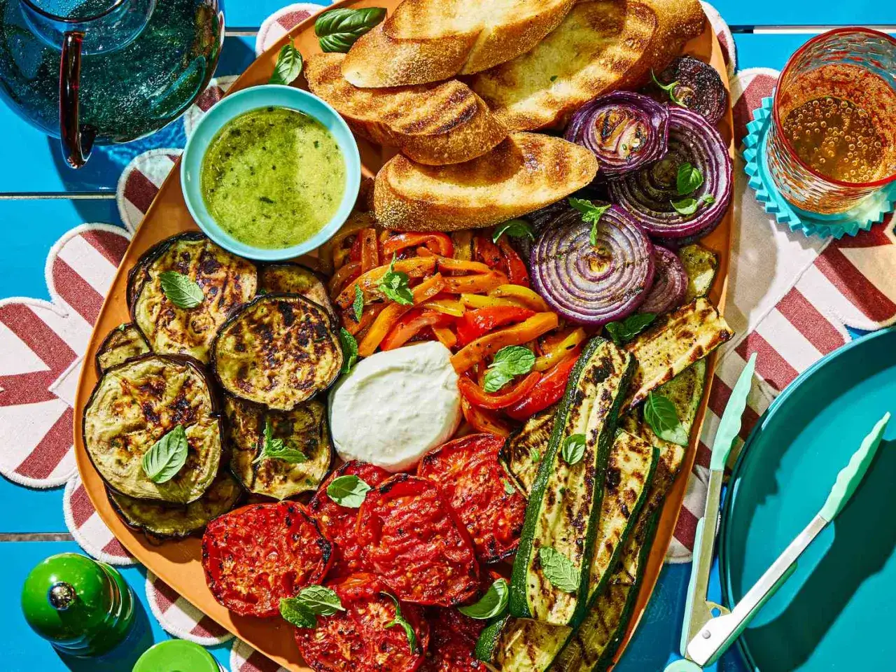 Pyszne przekąski do grilla: grillowane warzywa, pieczywo, sos i ser. Idealne na letnie spotkania.